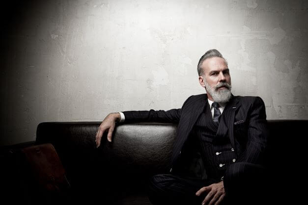 What Shoes To Wear With Suits: The Ultimate Guide 11 confident businessman in a three-piece suit