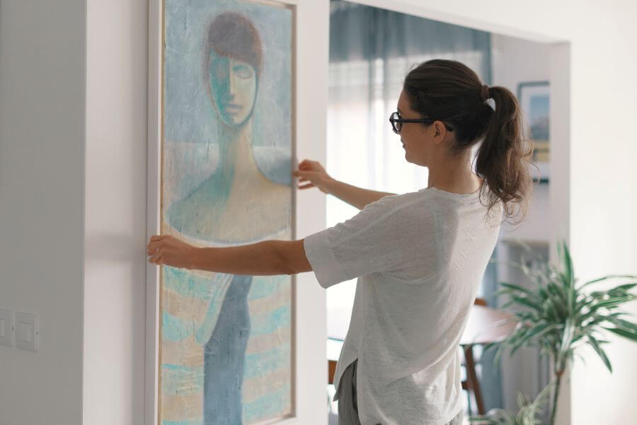 Is collecting art worth it? 2 woman puts up art at home