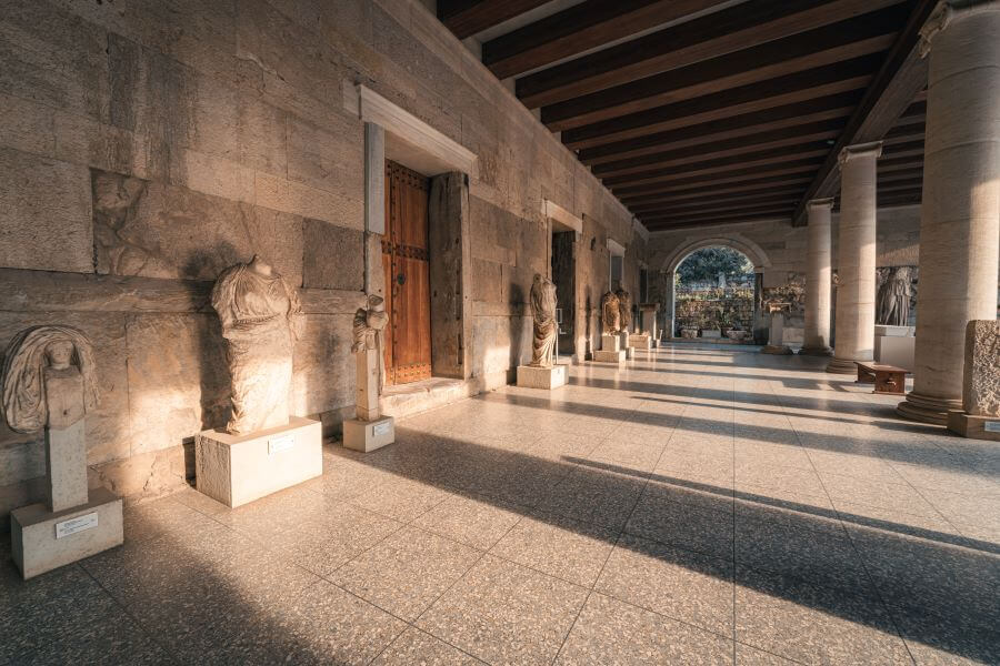 Ancient monuments to visit in Greece 8 The column and statues at Stoa of Attalos in Ancient Agora of Athens
